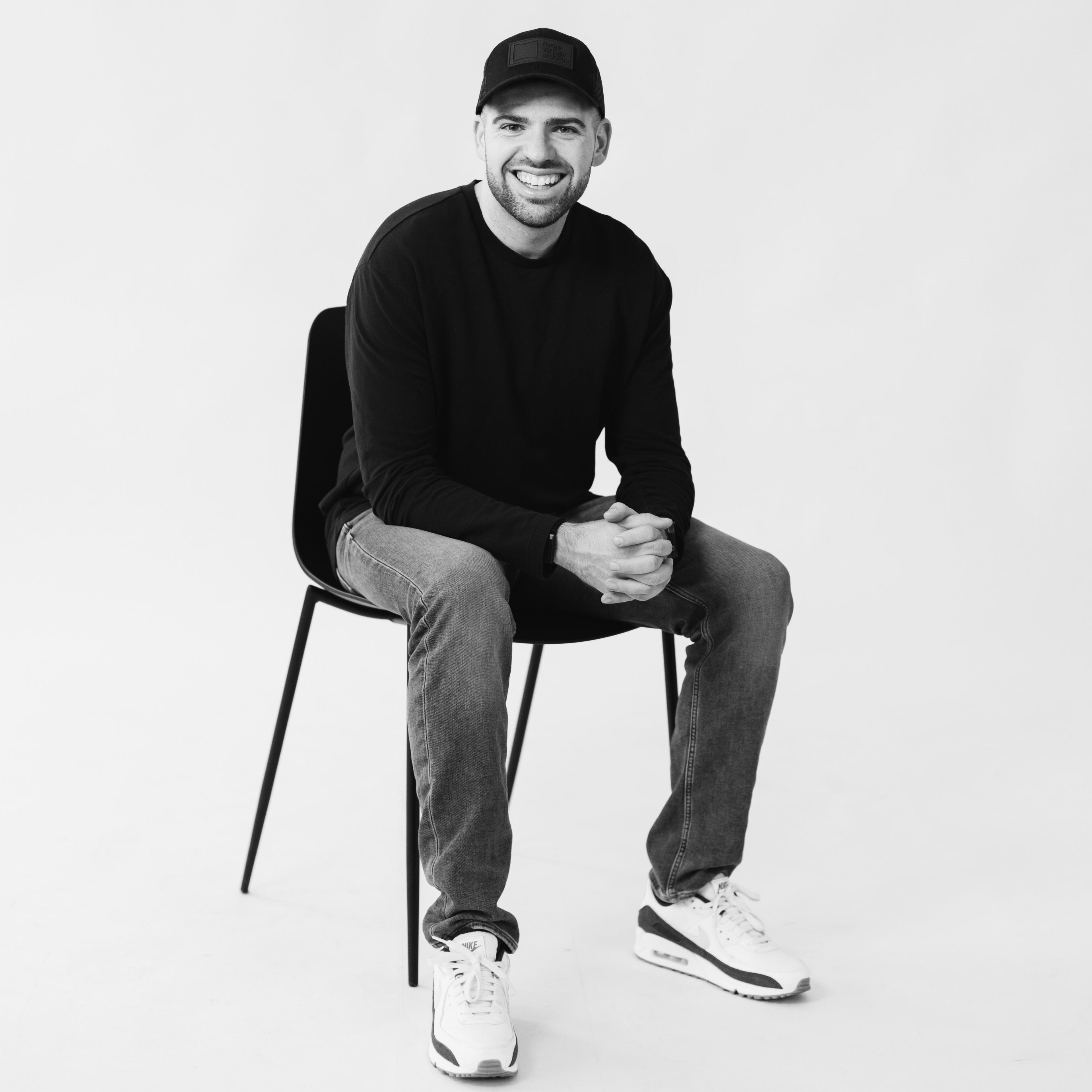 Drew English Drew english sitting in a chair for a headhost
